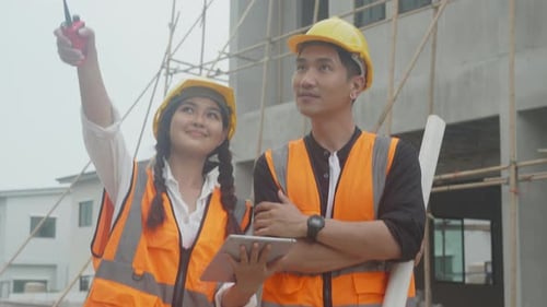 Group team of engineer and architect holding blueprint and explaining using radio communication.