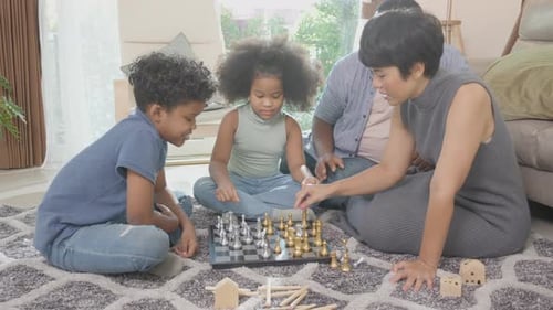 Family Playing Chess Together Indoors
