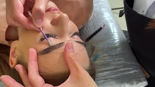 Cosmetic Eyebrow Cleaning with Cotton Swab Close Up