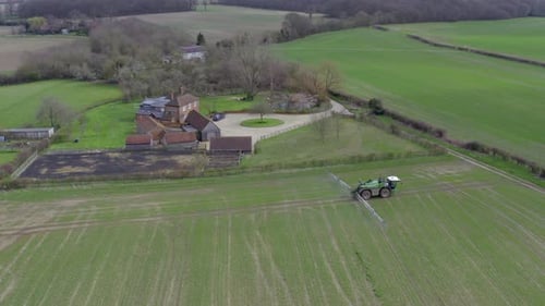 Tractor Sprays Green Field on English Farm