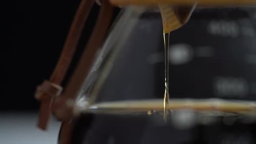 Amber Coffee Dripping into Glass Carafe, Close Up