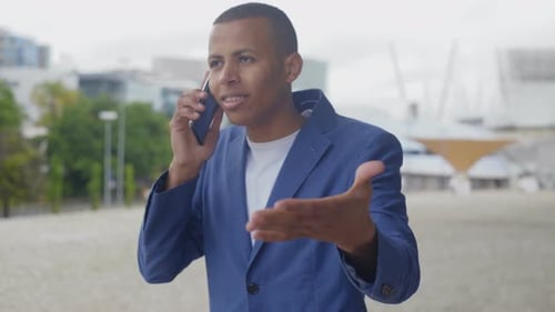 Young Adult Man Talking on Phone Outdoors