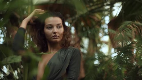 Woman Posing Elegantly in Tropical Greenery