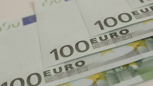 Hundred euro banknotes arranged on table shallow DOF 4K 2160p 30fps UltraHD panning footage - Deno