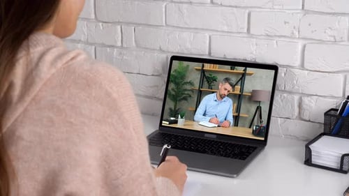 Woman Attending a Video Conference from Home