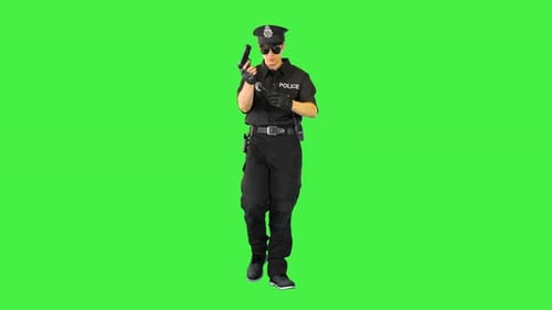 Policeman Walks Doing Some Exercices with His Gun on a Green Screen Chroma Key