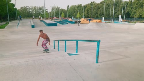 Young Adult Skateboarding Stunt in Urban Skate Park