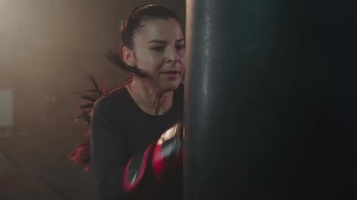 Strong Woman Boxing with Red Gloves
