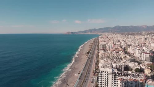 Beautiful seashore with beach, resort city and car freeway.