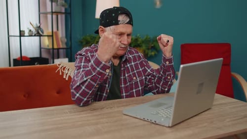 Overjoyed Senior Grandfather Man with Laptop Celebrate Success Win Money in Lottery Online Good News