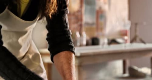 Artisan Shaping Clay in Bright Studio