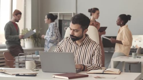 Middle Eastern Male Interior Designer Working in Office
