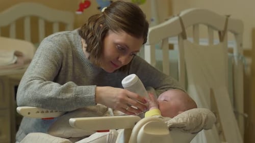 Mother Bottle Feeds Baby