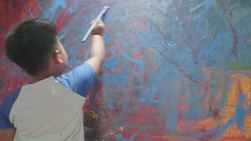 Child Painting Abstract Art on Canvas Indoors