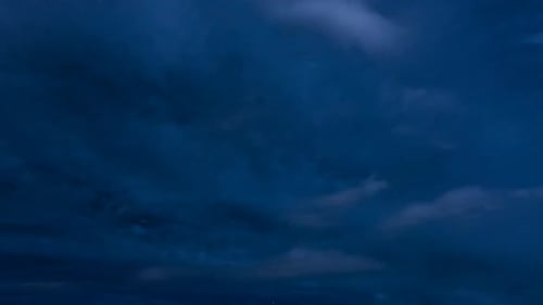 Night Sky Clouds Time-Lapse Over Mountain Cityscape