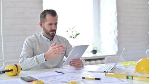 Failure Young Architect Having Loss on Tablet in Office