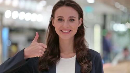 Young Woman Gives Thumbs Up Approval