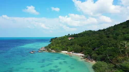 Paradise tropical island with beautiful shore, white sandy beaches, lush vegetation and limestone cl