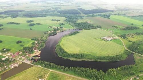 View From the Height of the Lake in a Green Field in the Form of a Horseshoe and a Village in the