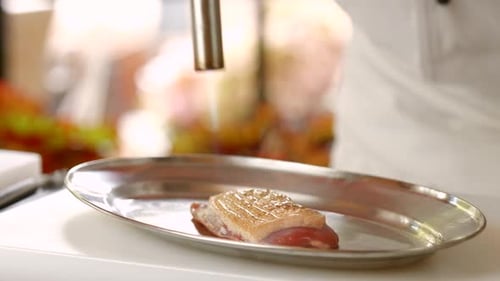 Chef Prepares Food with Blow Torch in Kitchen