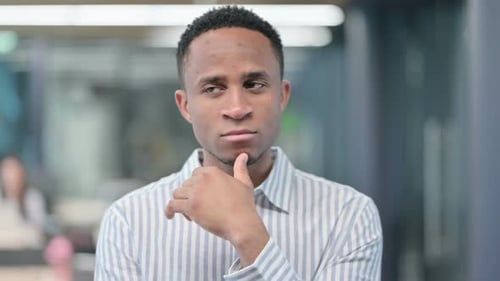 Young Adult Pondering in Office Environment