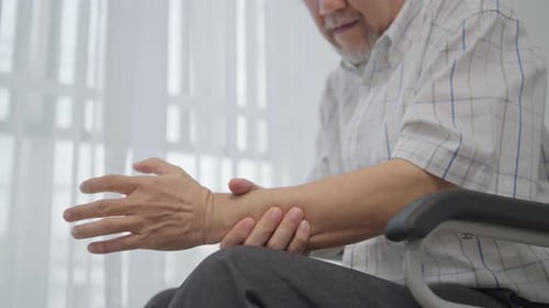 Senior Adult Rubbing Sore Wrist at Home