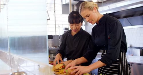 Chefs Preparing Burgers and Sandwiches in Restaurant Kitchen