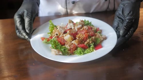 Chef Presents Delicious Chicken Salad on Table