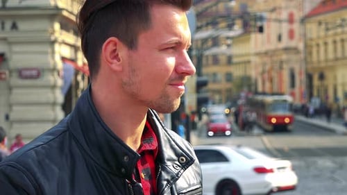 A Young Handsome Man Takes Photos with a Camera - Face Closeup - a Busy Street