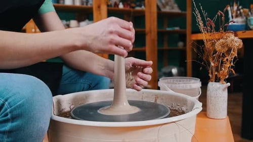 Potter Shaping Clay on a Pottery Wheel