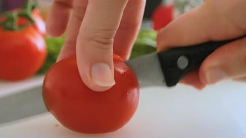 Tomato Being Sliced With Sharp Knife Close Up