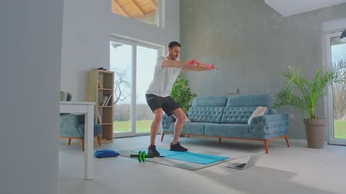 Man Exercising with Resistance Band in Living Room