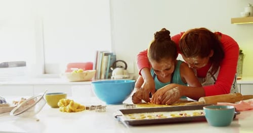 Mother and Child Making Cookies Together in Kitchen