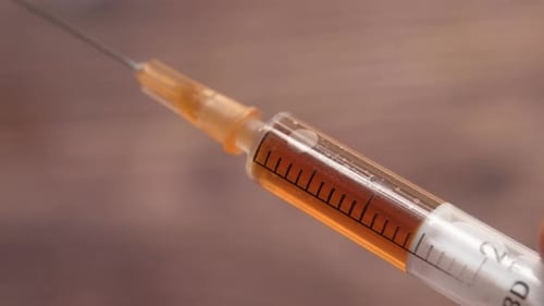 Doctor Hand Medical Gloves Holding Syringe
