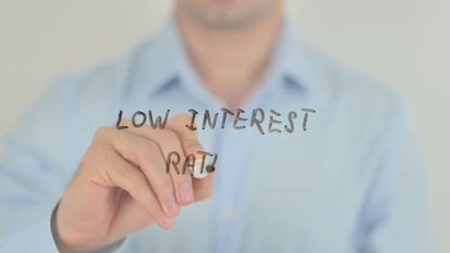 Low Interest Rates, Man Writing on Transparent Glass Screen