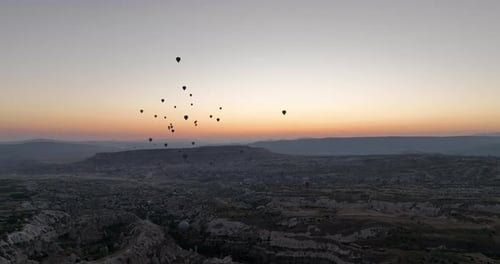 Aerial Cinematic Drone View of Colorful Hot Air Balloon Flying Over Cappadocia