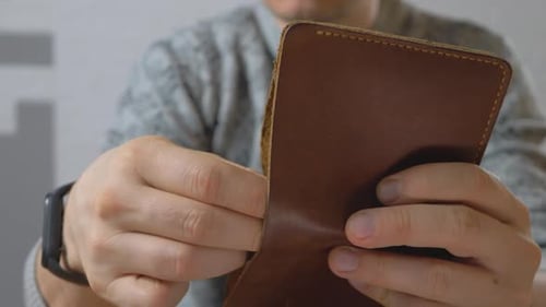Person Showing Cash Inside Brown Leather Wallet