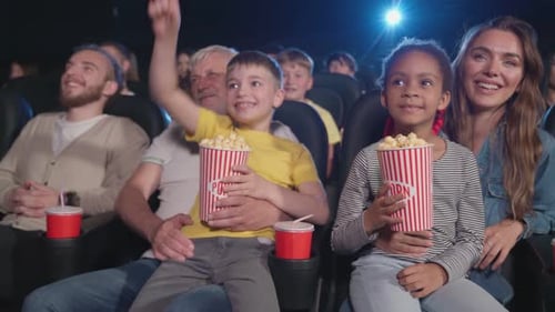 Parents with Kids on Knees in Cinema
