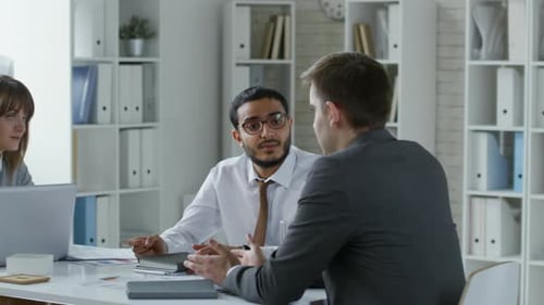 Multiethnic Business Professionals Having Discussion at Office Table