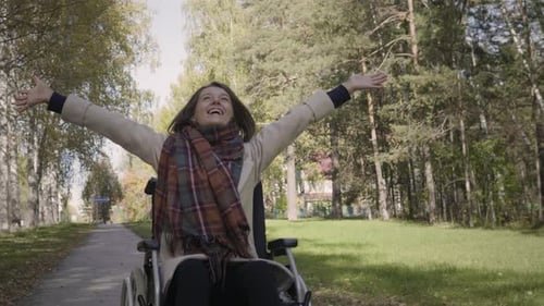 Woman in Wheelchair Enjoys Nature in the Autumn