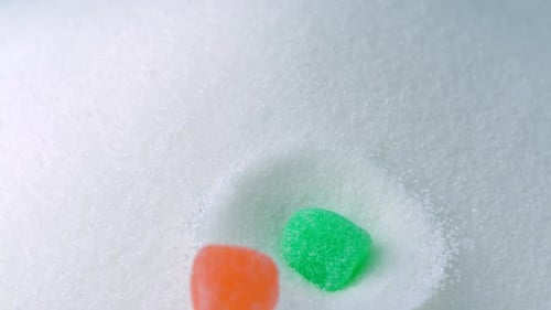 Gummy Candies Falling onto Sugar