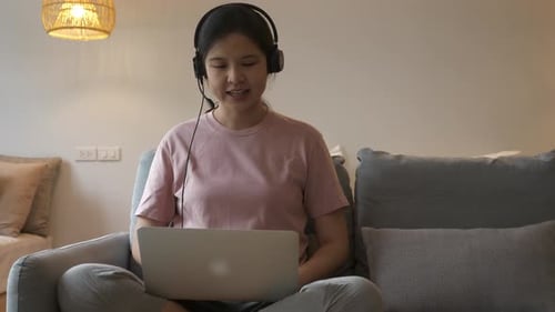 Young Woman Talking on Laptop at Home