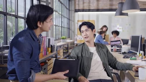 Young Men Discussing Business in Modern Office