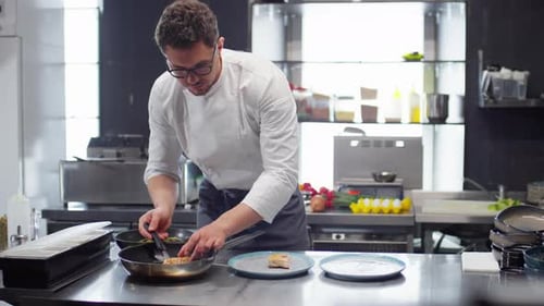 Chef Preparing Orders in Restaurant Kitchen