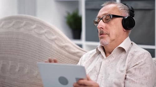 Senior Man Video Calling on Tablet at Home
