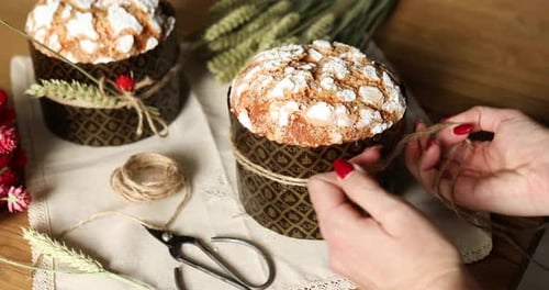 Woman Decorates Holiday Cake with Twine