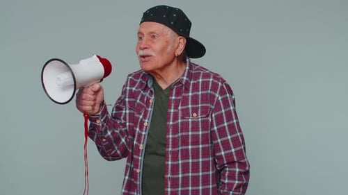 Senior Man Speaking Into A Megaphone