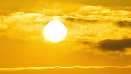 Dramatic Golden Sun Shining Through Clouds at Sunset