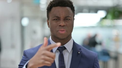 Young Adult Angry and Pointing in a Workplace