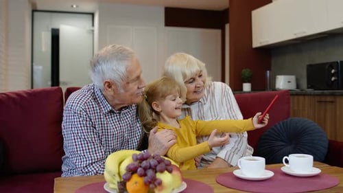 Grandparents Take Selfie with Grandchild at Home